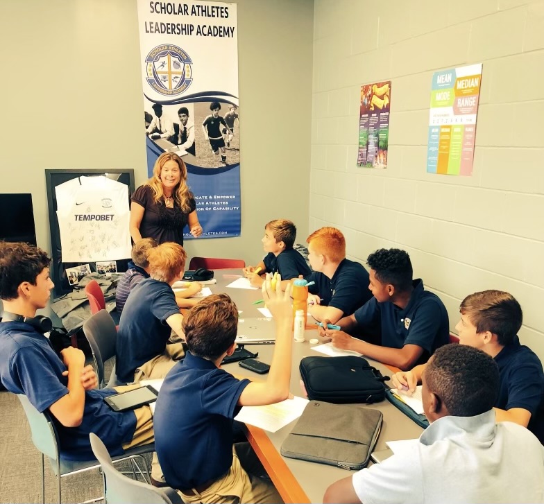 A group of students sitting around a table.