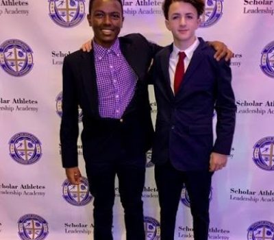 A pair of young men pose for a photo at a SALA event.